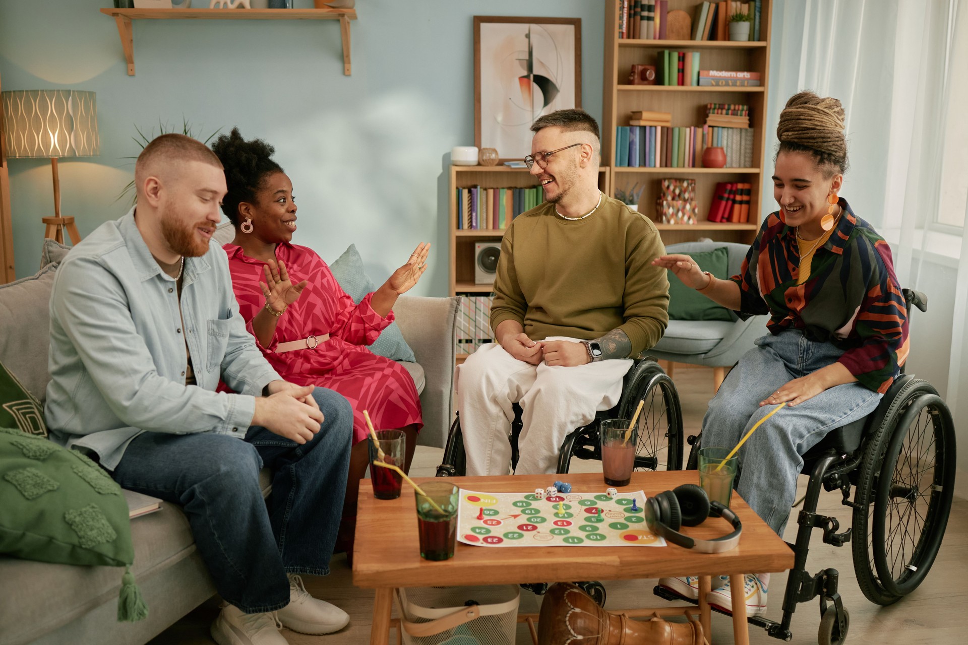 Diverse Young Adults with Disability Celebrating Birthday and Playing Board Game